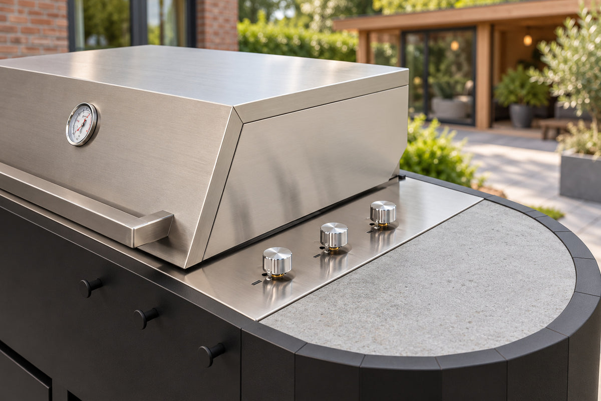 Close-up Q-boo OVO GS gasbarbecue: RVS grilldeksel met thermometer, drie bedieningsknoppen en Dekton werkblad
